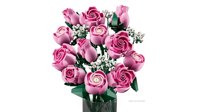 Full view of the LEGO Bouquet of Pink Roses, with green stems visible, partially obscured by a glass vase.
