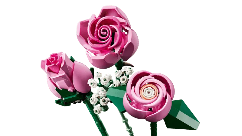 Close-up of three LEGO pink roses and white baby's breath elements, showing stem details.