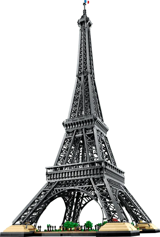 Angled view of the completed LEGO Eiffel Tower 10307 model, emphasizing its height and the intricate details of its structure, with a small French flag at the very top.