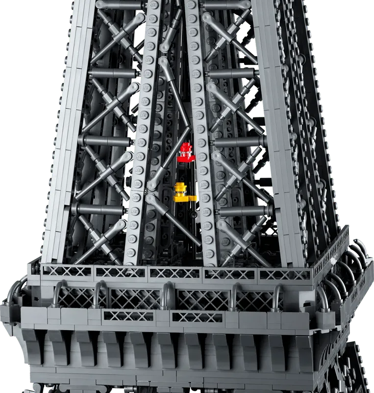 Close-up view of the interior structure of the LEGO Eiffel Tower 10307, revealing intricate scaffolding and a tiny red and yellow elevator shaft detail.