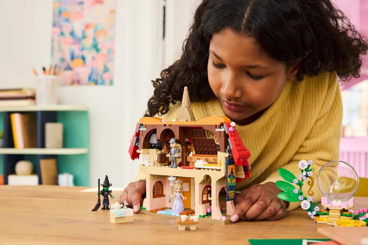 Child exploring LEGO house.