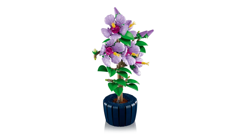 Side view of the assembled Lego Hibiscus plant on a white background, highlighting its depth and profile, with light purple flowers and dark blue pot.