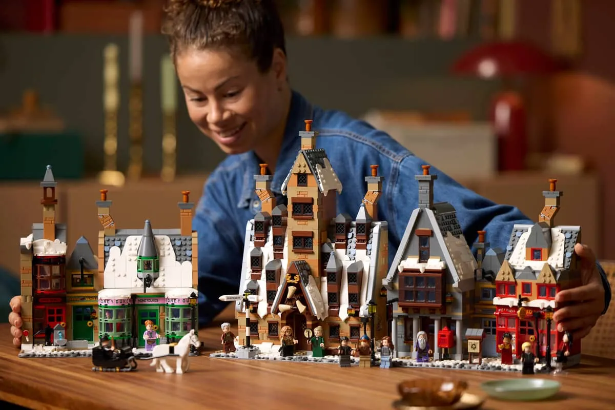 Person admiring Hogsmeade Village set.