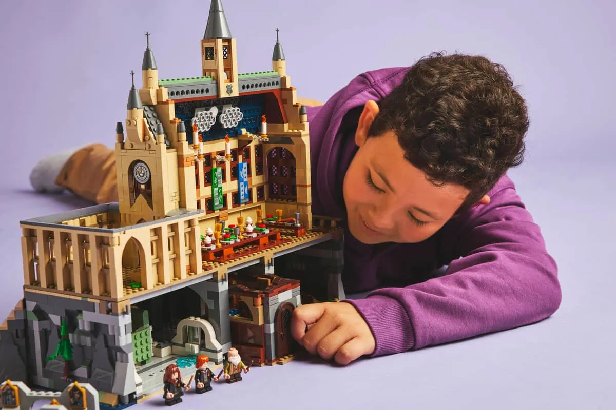 Child playing with combined Hogwarts Castle.