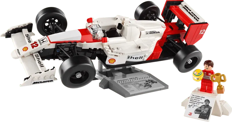 The Lego McLaren MP4/4 model displayed on its stand next to the Ayrton Senna minifigure and his display base.