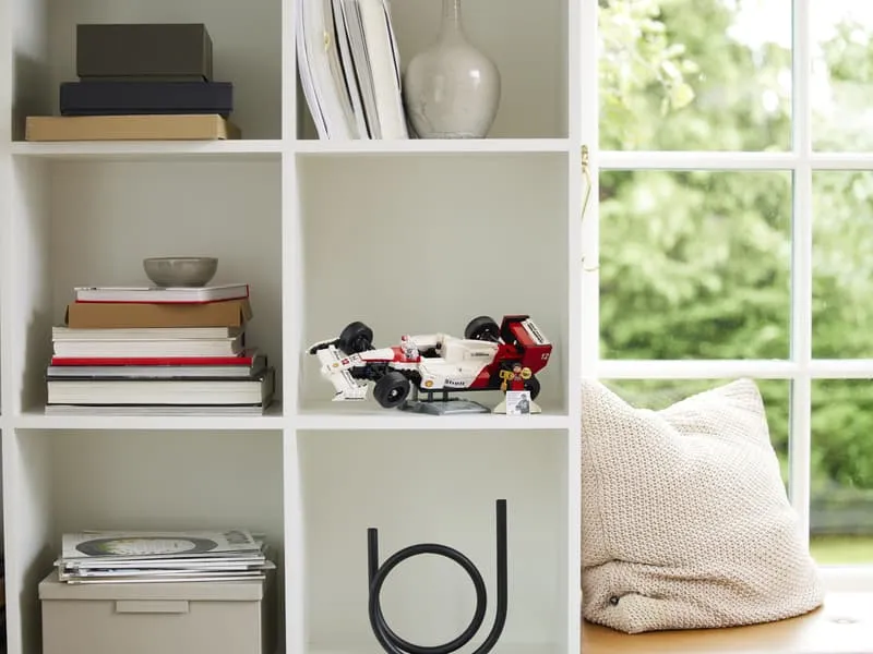 The Lego McLaren MP4/4 model displayed proudly on a shelf in a home setting.
