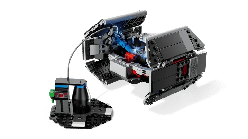 Darth Vader's TIE Fighter with its upper panels open, connected by a blue cable to a small black charging or data transfer station, revealing internal mechanisms.