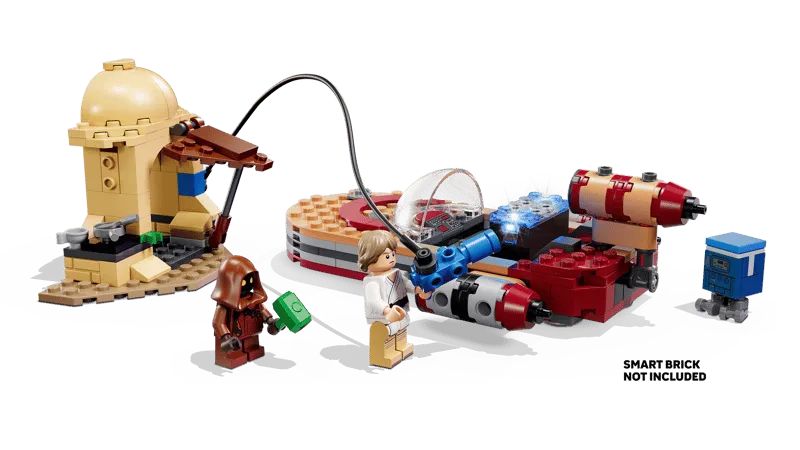 The LEGO Star Wars: Luke's Landspeeder 75420 set demonstrating the 'SMART PLAY' feature, with Luke Skywalker connecting a blue 'Smart Brick' into the X-34 Landspeeder, which emits blue light, while the Jawa and GNK droid stand nearby. Text 'SMART BRICK NOT INCLUDED' is visible.