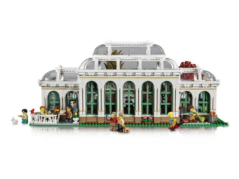 Front view of the assembled Lego The Botanical Garden 21353 model, featuring minifigures interacting around the greenhouse and garden.