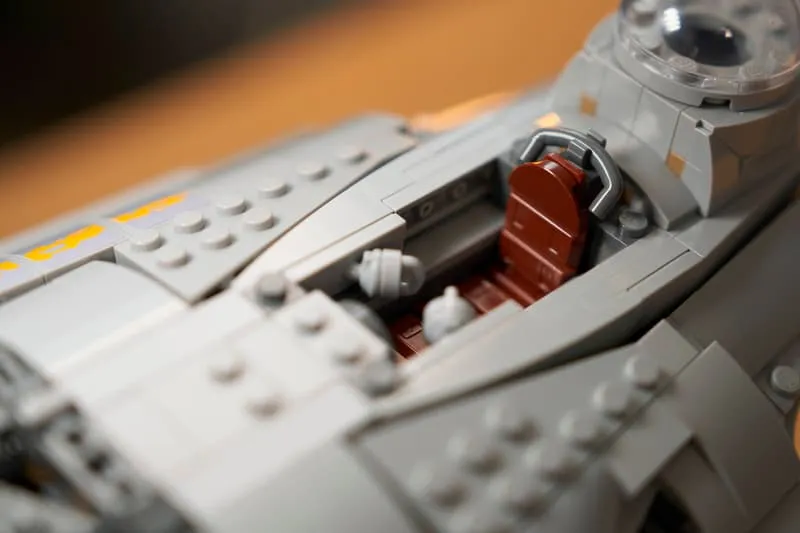 Another close-up of the Lego N-1 Starfighter UCS cockpit, focusing on the pilot's brown seat and control panels from a different angle.