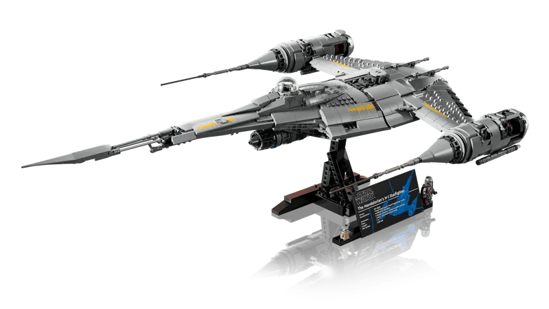 Angled view of the Lego N-1 Starfighter UCS model on its display stand, with the info plaque and minifigures clearly visible.