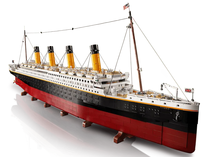 Front-angled view of the fully assembled LEGO Titanic model, highlighting the bow, black hull, and golden funnels.