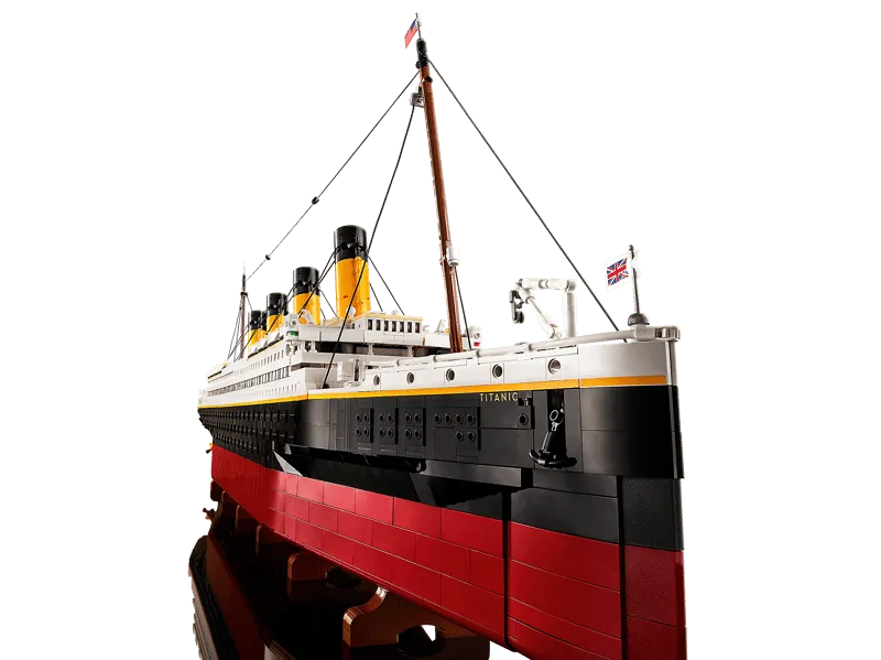Close-up shot of the bow of the assembled LEGO Titanic model, showing intricate details like the anchors, railings, and the ship's name.