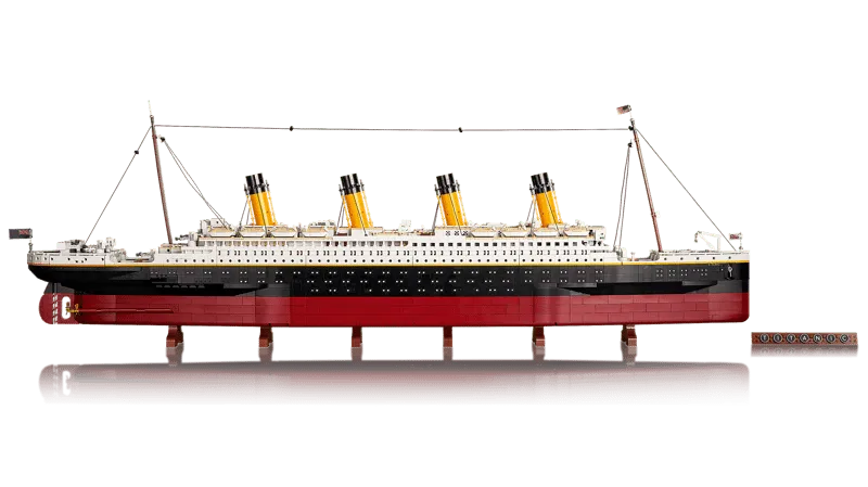 Full side view of the assembled LEGO Titanic model, showing its complete profile and immense length, along with the display plaque.
