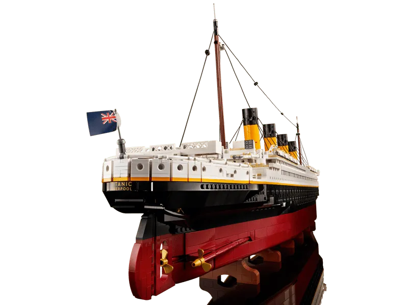 Angled view of the stern of the assembled LEGO Titanic model, featuring the Union Jack flag, propeller details, and rudder.