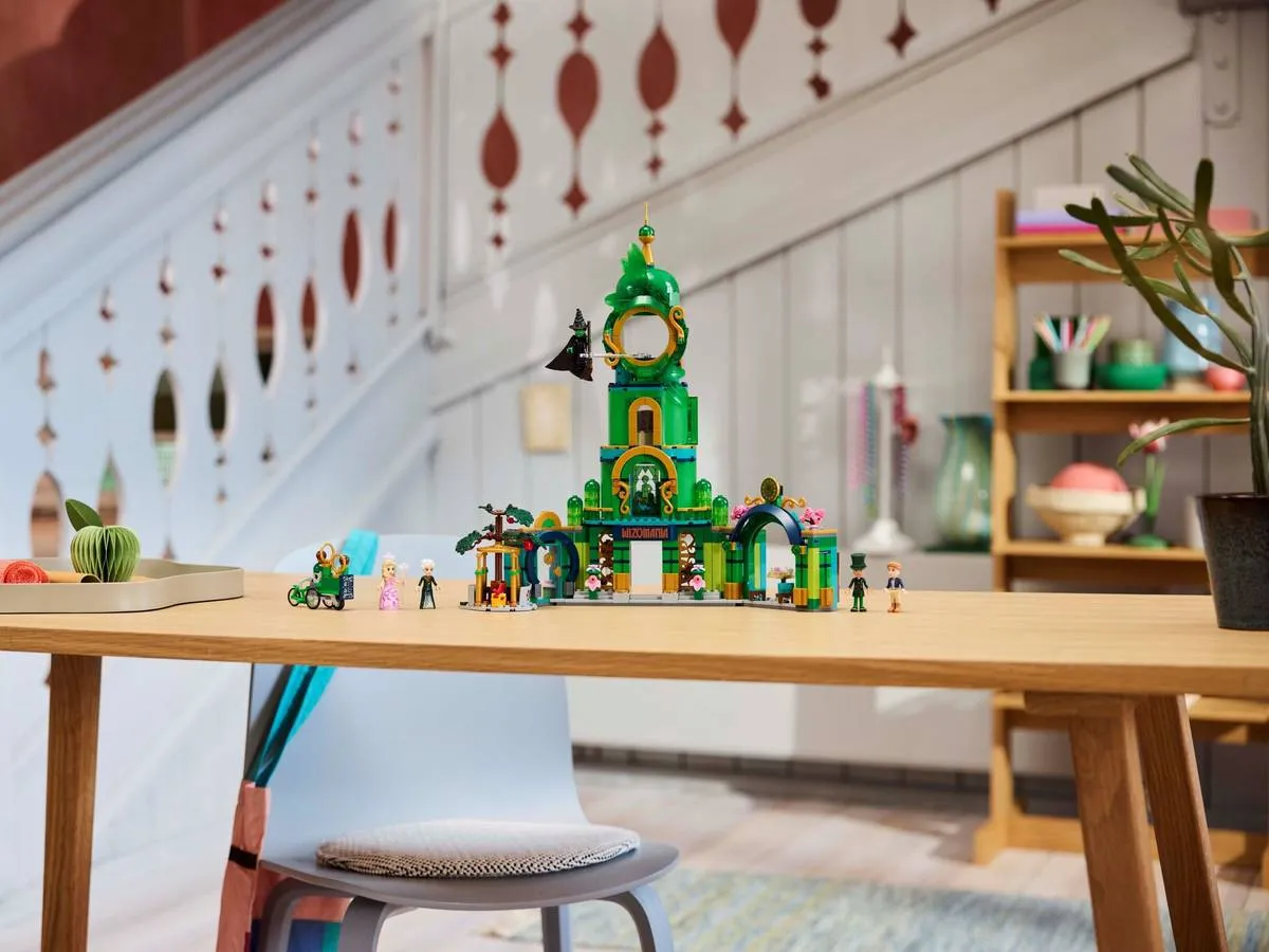 The full Lego Welcome to Emerald City 75684 set displayed prominently as a centerpiece on a wooden table in a well-decorated room, showcasing its grandeur and vibrant colors.