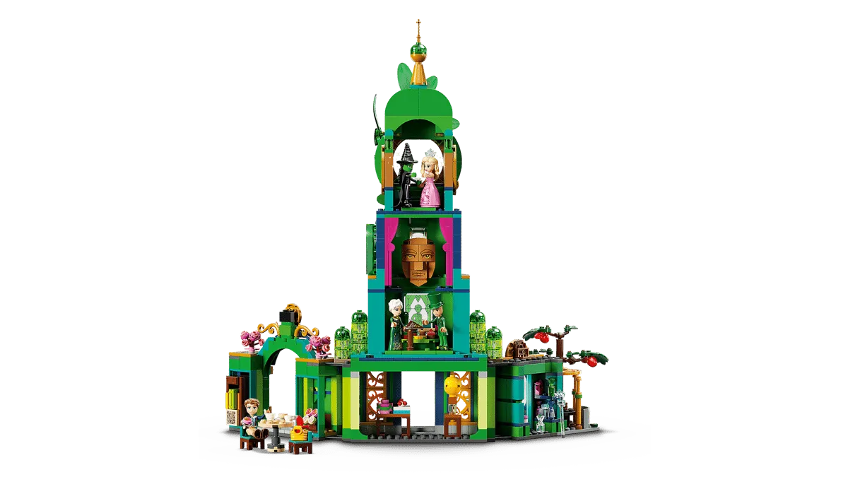 A side view of the Lego Welcome to Emerald City 75684 set, revealing interior details of the central tower, including the Wizard's head, and various rooms with minifigures interacting, all against a white background.