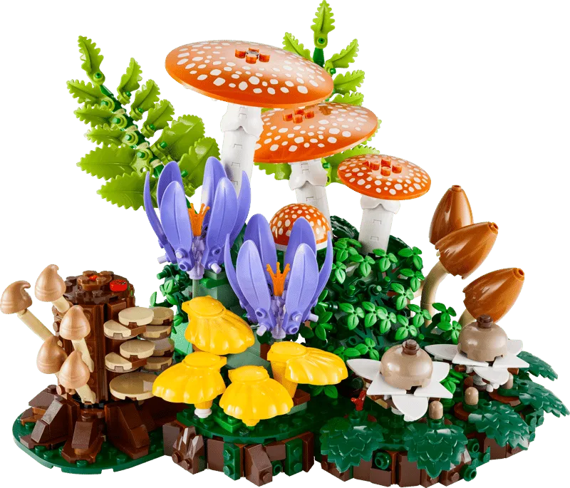 A fully assembled LEGO Woodland Mushrooms 11505 set, featuring various types of mushrooms, purple and yellow flowers, and green foliage on a dark green base, against a plain white background.