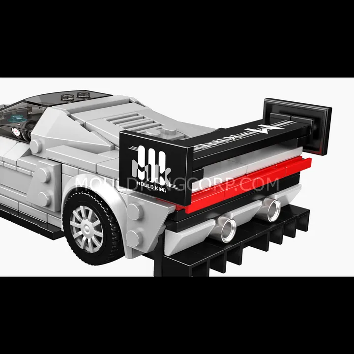 Close-up rear view of the Mould King KC23 Supercar block model, showcasing the large adjustable rear wing with 'Mould King' branding, twin exhaust pipes, and a pronounced rear diffuser.